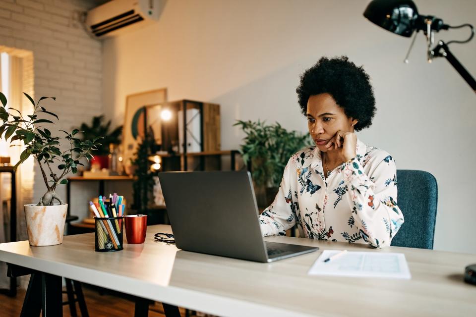 woman working on laptop at home office