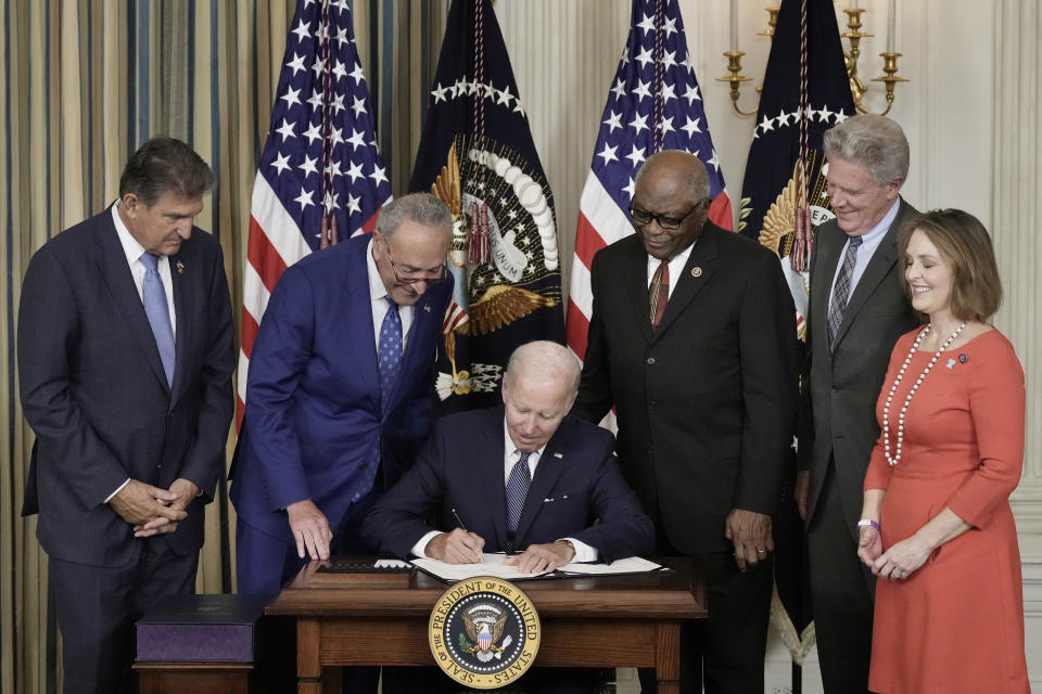 WASHINGTON, DC - AUGUST 16: U.S. President Joe Biden (C) signs The Inflation Reduction Act with (L-R) Sen. Joe Manchin (D-WV), Senate Majority Leader Charles Schumer (D-NY), House Majority Whip James Clyburn (D-SC), Rep. Frank Pallone (D-NJ) and Rep. Kathy Catsor (D-FL) in the State Dining Room of the White House August 16, 2022 in Washington, DC. The $737 billion bill focuses on climate change, lower health care costs and creating clean energy jobs by enacting a 15% corporate minimum tax, a 1-percent fee on stock buybacks and enhancing IRS enforcement.  (Photo by Drew Angerer/Getty Images)
