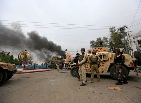 Afghan security forces keep watch during blasts and gunbattle at the site in Jalalabad city, Afghanistan May 13, 2018.REUTERS/Parwiz