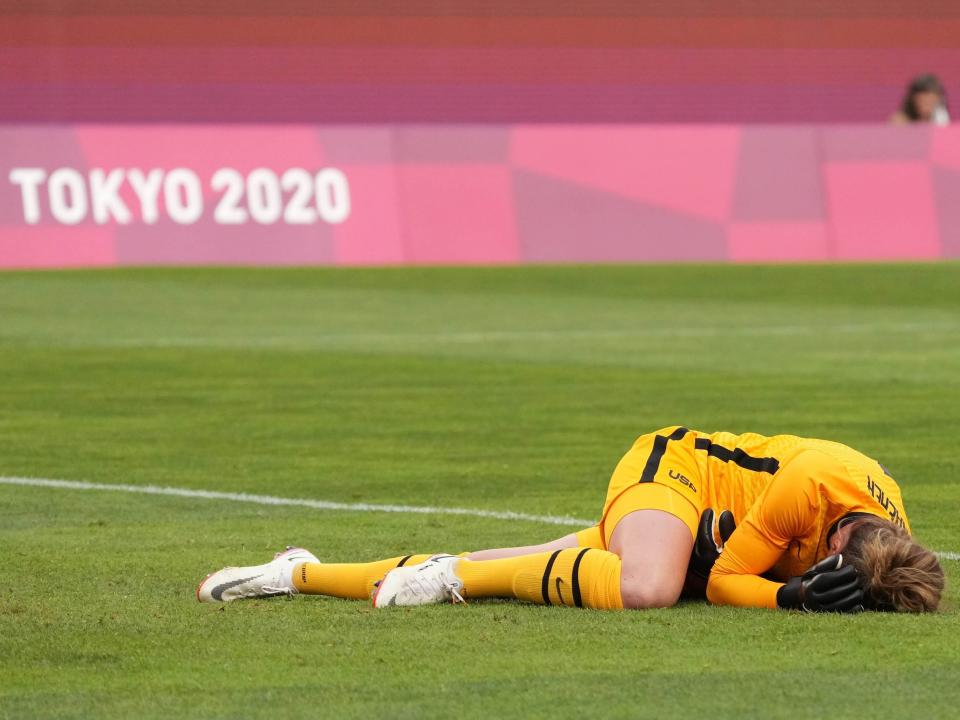 Alyssa Naeher lays on the turf following a first-half collision during the USWNT game vs Canada.