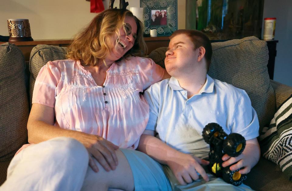 Annette Maughan relaxes with her son Glenn Maughan, nicknamed Bug, at their home in Manchester, Md., on Saturday night, July 8, 2023. Bug, age 20, has KBG syndrome. He is nonverbal and currently experiences one to three seizures a day. | Kristin Murphy, Deseret News