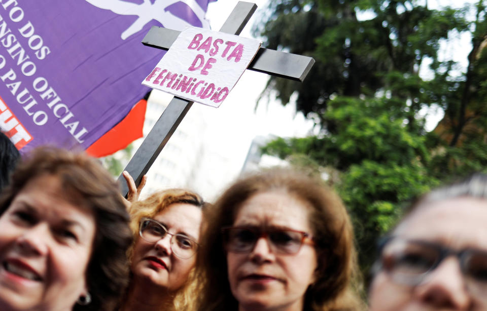 <p>A crosss with a sign reading “Enough of Femicide” is pictured next to women during the rally on the World Day for the Elimination of Violence against Women in Sao Paulo, Brazil, Nov. 25, 2017. (Photo: Nacho Doce/Reuters) </p>