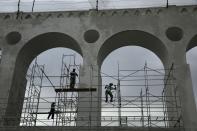 Workers prepare scaffolds to paint the Arcos da Lapa (Lapa Arches), an old aqueduct from the colonial era, in Rio de Janeiro April 16, 2014. Rio de Janeiro is one of the host cities for the 2014 World Cup in Brazil. REUTERS/Pilar Olivares (BRAZIL - Tags: SPORT SOCCER WORLD CUP TRAVEL BUSINESS CONSTRUCTION)