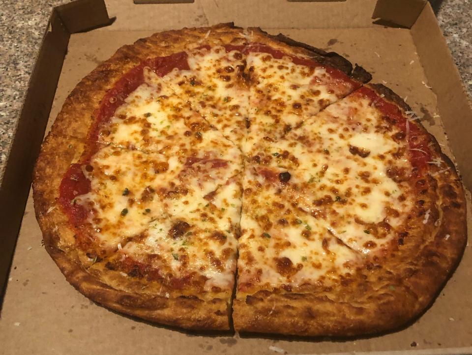 A thick-crust cheese pizza in a box