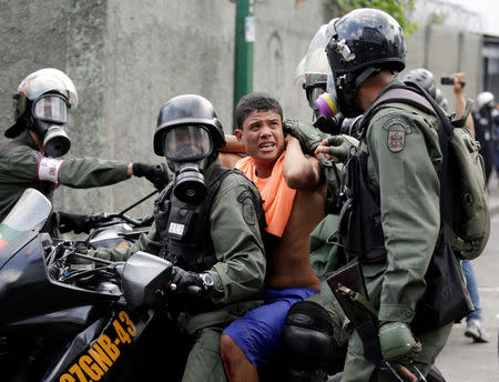 An opposition supporter is detained by riot police during a rally against Venezuela's President Nicolas Maduro in Caracas, Venezuela, April 26, 2017. REUTERS/Marco Bello