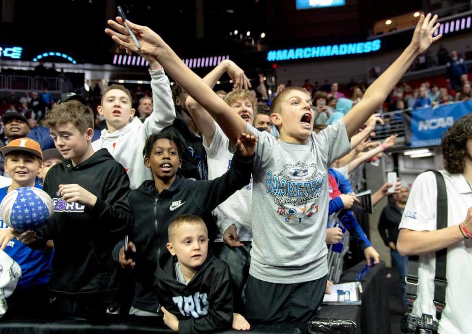 Basketball fans scream to get Kansas forward Jalen Wilson’s attention for autographs after the team’s shoot around a day ahead of Kansas’ first round game against Howard in the NCAA college basketball tournament Wednesday, March 15, 2023, in Des Moines, Iowa.