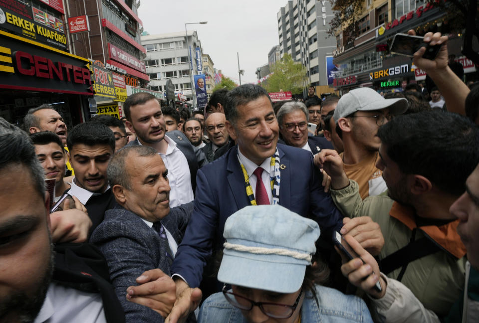 FILE - Sinan Ogan, center, an academician and presidential candidate from ATA alliance, formed of nationalist political parties, is surrounded by supporters during a city tour, in Ankara, Turkey, Thursday, May 4, 2023. Turkey is heading toward presidential and parliamentary elections on Sunday May 14, 2023. (AP Photo/Burhan Ozbilici, File)