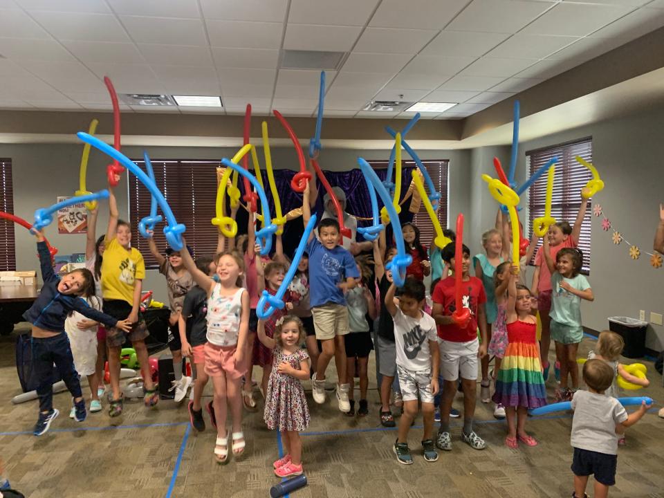 Happy visitors made balloon swords to take home at the library in July.