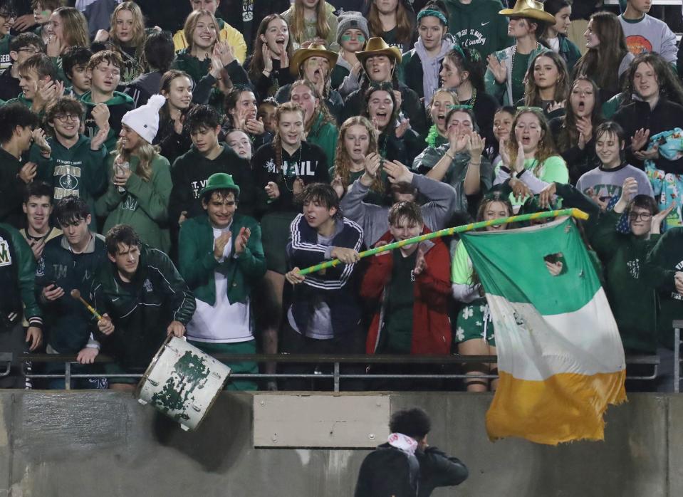 St. Vincent-St Mary High fans cheer for a camera before the start of the Division II regional semifinal against Hoban at the University of Akron.