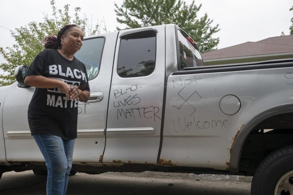 Candace Hall stands in front of graffiti written on her truck in front of her Warren, Mich., home on Thursday, Sept. 10, 2020. (David Guralnick/Detroit News via AP)