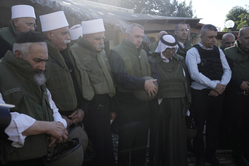 Faith leaders from the Druze, Muslim, Jewish and Christian communities hold an interfaith prayer at Kibbutz Kfar Azza near the Israel-Gaza border, the site of an Oct. 7 cross-border attack by Hamas who killed some 1,200 people, Wednesday, Nov. 29, 2023. (AP Photo/Maya Alleruzzo)