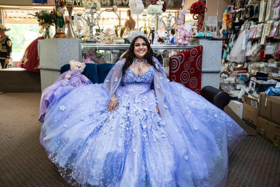 Daniela Robledo smiles at the fitting for her quinceañera dress at Yolandas Creations on Central Avenue in Charlotte. Robledo spent her youth watching shows about young Latina women having their quinceañera and dreaming about her own. When she approached her sixteenth birthday, her parents asked if she would like a car or a quinceañera, she chose the latter. 