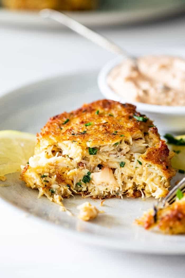 Crab cake with a bite taken out of it.