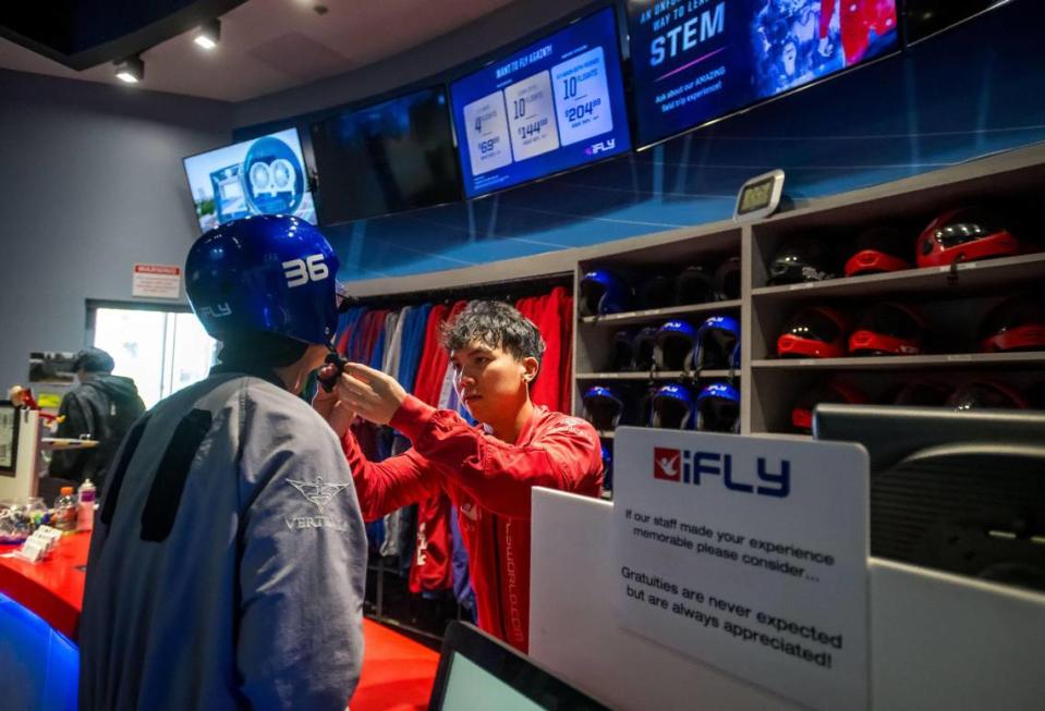 Instructor Hao Phan, center, adjusts a helmet on Corey Kashiwagi, of Sacramento, before a trio of first-timers at iFly Indoor Skydiving on Sept. 20, 2023, in Roseville.
