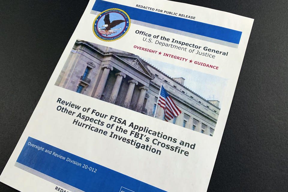 The cover page of the report issued by the Department of Justice inspector general is photographed in Washington, Monday, Dec. 9, 2019. The report on the origins of the Russia probe found no evidence of political bias, despite performance failures. (AP Photo/Jon Elswick)