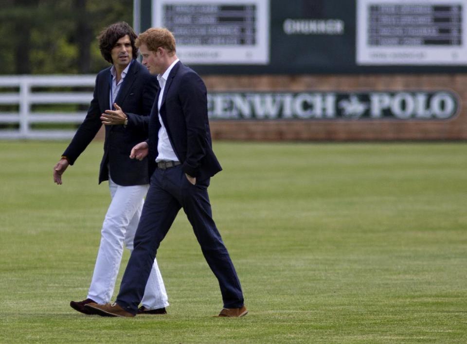 Britain's Prince Harry, right, walks with polo player Nacho Figueras before the Sentebale Royal Salute Polo Cup charity match in Greenwich, Conn., Wednesday, May 15, 2013. (AP Photo/Craig Ruttle)