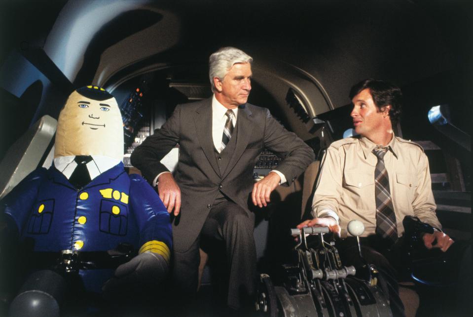 Otto the Auto Pilot, left, Leslie Nielsen and Robert Hays in "Airplane!"