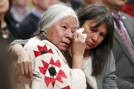 Residential School survivor Lorna Standingready (L) is comforted during the Truth and Reconciliation Commission of Canada closing ceremony at Rideau Hall in Ottawa, June 3, 2015. REUTERS/Blair Gable