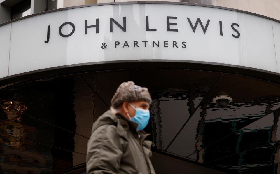 John Lewis A man wearing a face mask walks past a temporarily closed John Lewis department store on Oxford Street in London, Britain, March 24, 2021. REUTERS/John Sibley