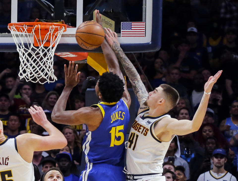 Denver Nuggets forward Juancho Hernangomez (41) blocks a shot by Golden State Warriors center Damian Jones (15) in the final seconds during the fourth quarter of an NBA basketball game, Sunday, Oct. 21, 2018, in Denver. The Nuggets beat the Warriors 100-98. (AP Photo/Jack Dempsey)