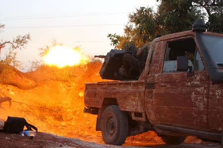 Members of al Qaeda's Nusra Front fire their weapon during an offensive to take control of the northwestern city of Ariha from forces loyal to Syria's President Bashar al-Assad, in Idlib province May 28, 2015. REUTERS/Ammar Abdullah