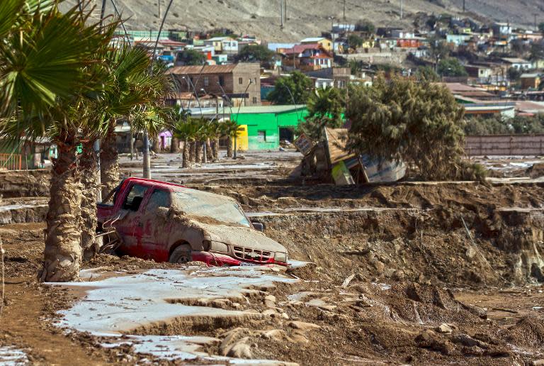 A car remains in the mud at an area which was flooded after heavy rainfall caused the overflowing of the Copiapo river and the flooding of parts of Chile, on April 1, 2015