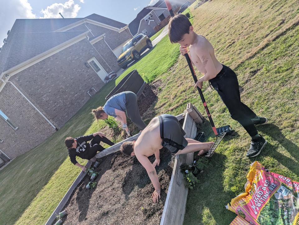 Michelle Schrodt gardening with the Smith boys at their shared garden in Nolensville, Tennessee