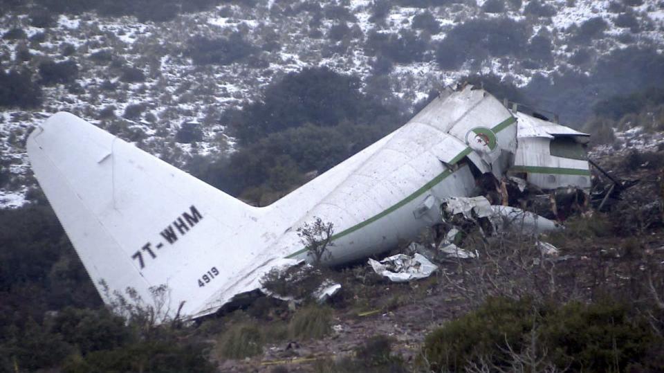 The wreckage of an Algerian military transport plane which slammed into a mountain Tuesday in the country's rugged eastern region, is pictured Wednesday, Feb. 12, 2014. The crash killed scores of people and left just one survivor, the defense ministry said. The plane was discovered in pieces on Mount Fortas near the town of Ain Kercha, 50 kilometers (30 miles) southeast of Constantine, the main city in eastern Algeria. (AP Photo/Anis Belghoul)