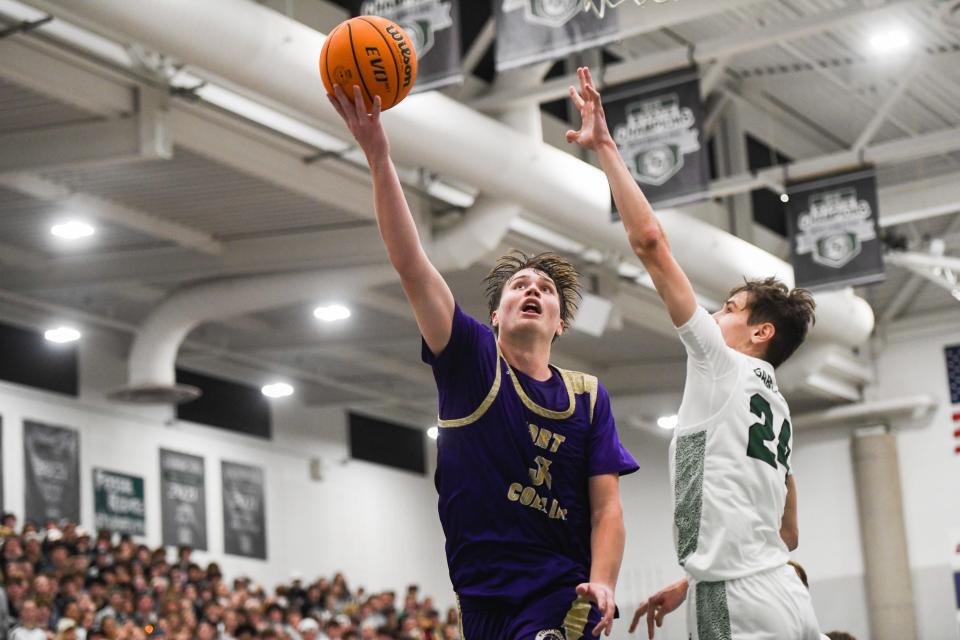 Fort Collins' Luke Wagstaff (33) scores a layup in a boys high school basketball game against Fossil Ridge at Fossil Ridge High School in Fort Collins on Tuesday.