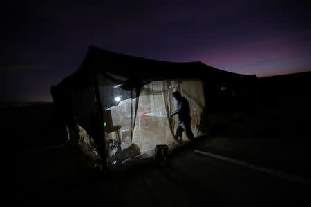 Undocumented Bolivian migrant known as Ramiro, 39, arrives at the camp where he works at the Chilean and Peruvian border, near Arica, Chile, November 17, 2018. REUTERS/Ivan Alvarado