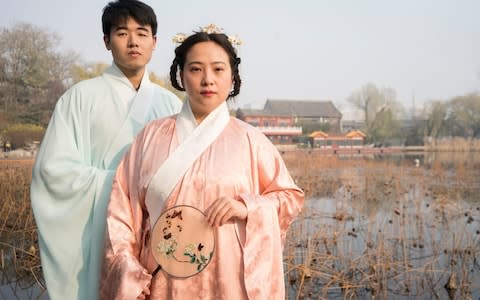 Liu Jingqiu (right), 32, and her partner He Shipeng, pose in traditional Han clothing in Xihai, Beijing - Credit: Giulia Marchi for The Telegraph