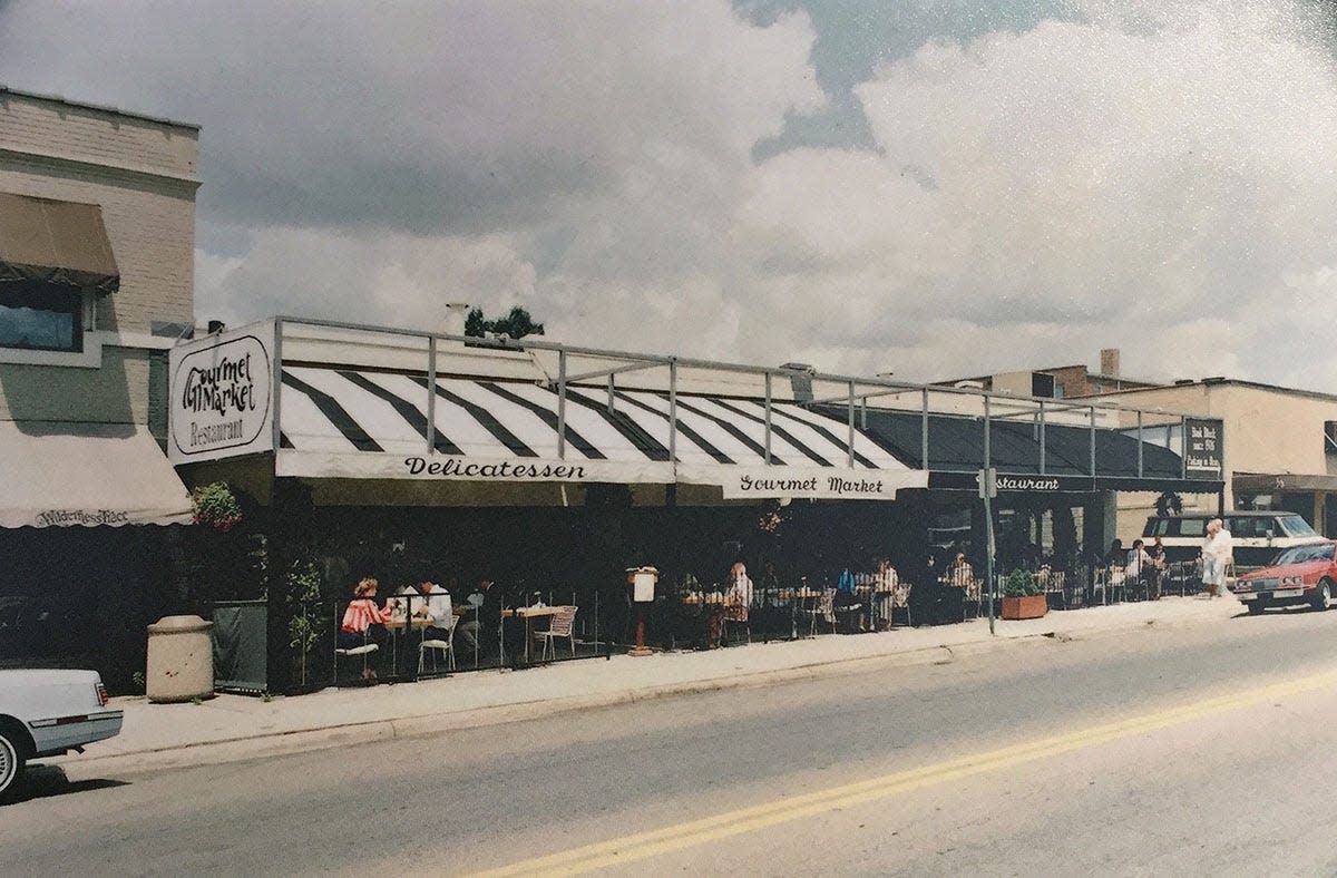 The Gourmet Market, later known as Spagio, is shown in a 1980s era photograph. The deli/restaurant is regarded as instrumental in the revival of the successful commercial strip along Grandview Avenue.
