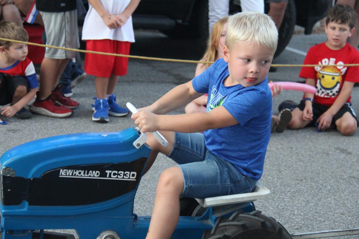 Owen Menz, 5 of Perry, participates in the Ohana Pedal Power Tractor Pull during the Dallas Center Fall Festival on Friday, Aug. 26, 2022.