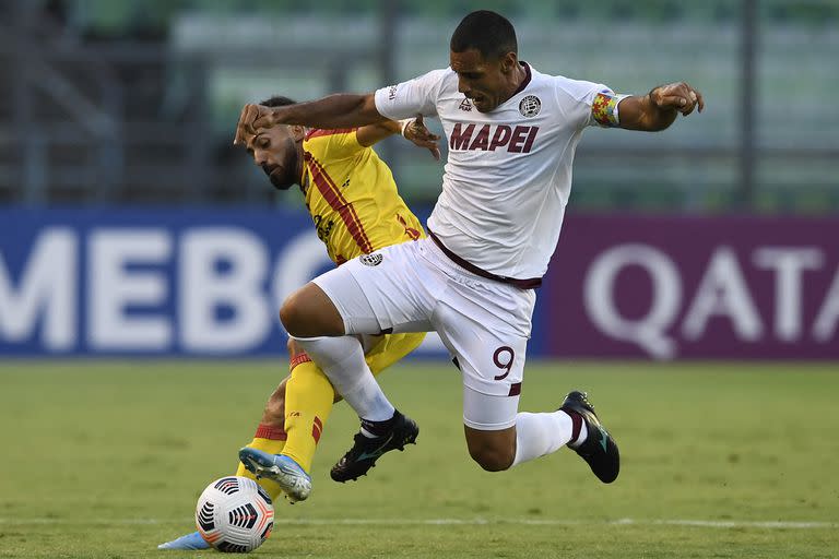 Jonathan Duche, de Aragua, ante Jose Sand, delantero de Lanús, por la Copa Sudamericana  (Photo by Federico Parra / AFP)