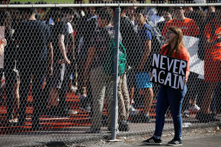 Students from Western High School carrying placards, take part in a protest in support of the gun control, following a mass shooting at Marjory Stoneman Douglas High School, in Davie, Florida, U.S., February 21, 2018. REUTERS/Carlos Garcia Rawlins