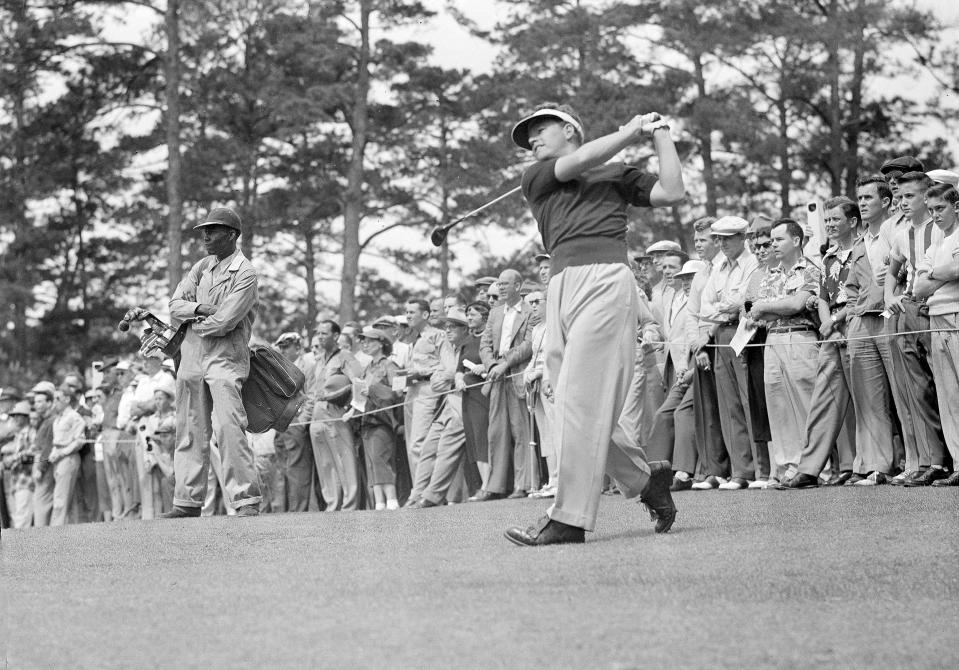 FILE - Jack Burke makes a long wood shot down the middle of the No. 2 fairway during the second round of Masters golf tournament in Augusta, Ga., April 4, 1952. At left is his unidentified caddy. Jack Burke Jr., the oldest living Masters champion who staged the greatest comeback ever at Augusta National for one of his two majors, died Friday morning, Jan. 19, 2024, in Houston. He was 100. (AP Photo/Horace Cort, File)