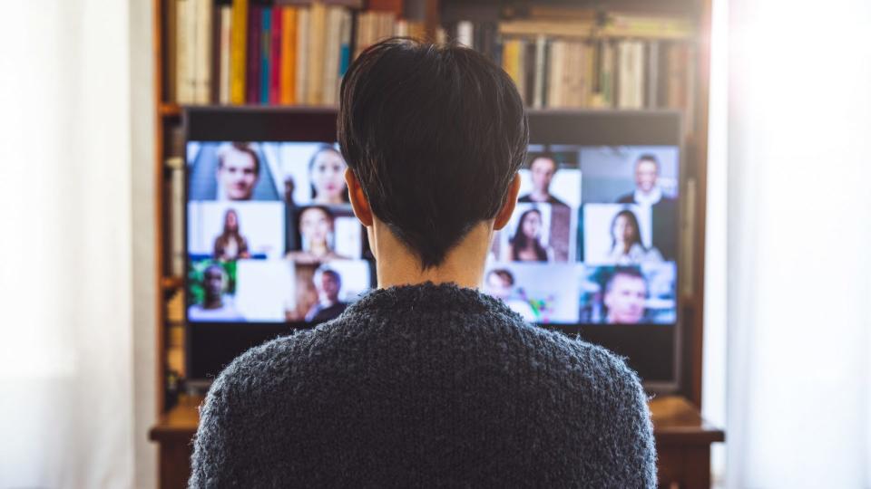 Woman in front of a device screen in video conference for work.