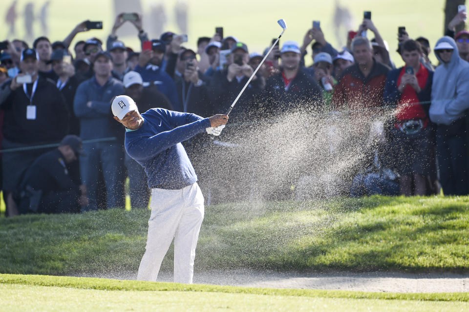 Tiger Woods hits out of the bunker on the first hole of the South Course at Torrey Pines Golf Course during the third round of the Farmers Insurance golf tournament Saturday Jan. 25, 2020, in San Diego. (AP Photo/Denis Poroy)