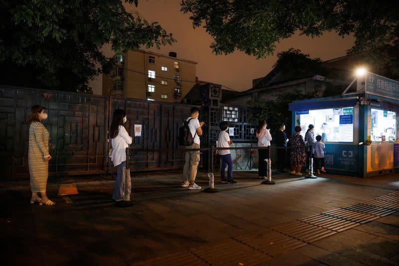 People line up to get a swab at a nucleic acid testing station, set up city-wide to trace possible coronavirus disease (COVID-19) outbreaks in Beijing