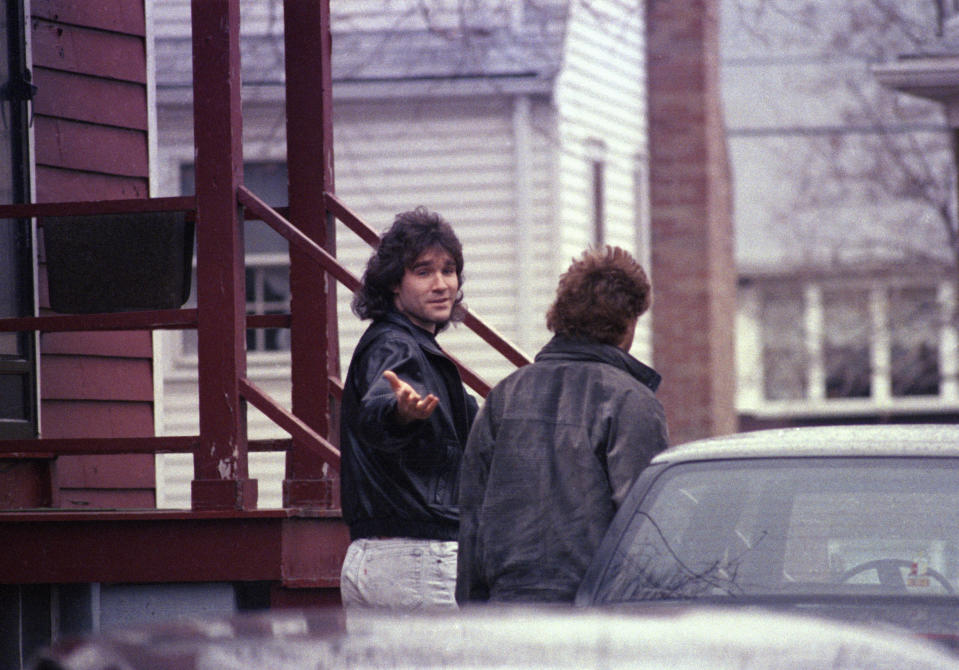 FILE - Matthew Stuart, brother of Charles Stuart, gestures toward members of the media outside his family's home in Revere, Mass., Jan. 10, 1990. On Wednesday, Dec. 20, 2023, Boston Mayor Michelle Wu plans to formally apologize on behalf of the city to Alan Swanson and Willie Bennett for their wrongful arrests following the 1989 death of Carol Stuart, whose husband, Charles Stuart, had orchestrated her killing. Matthew Stuart confessed to helping to hide the gun used to shoot Carol Stuart. (AP Photo/Jon Chase, File)