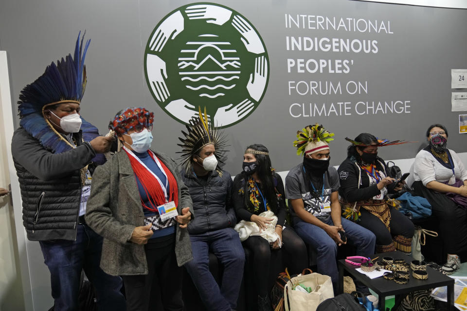 Indigenous delegates sit inside the venue of the COP26 U.N. Climate Summit in Glasgow, Scotland, Tuesday, Nov. 9, 2021. The U.N. climate summit in Glasgow has entered it's second week as leaders from around the world, are gathering in Scotland's biggest city, to lay out their vision for addressing the common challenge of global warming. (AP Photo/Alastair Grant)