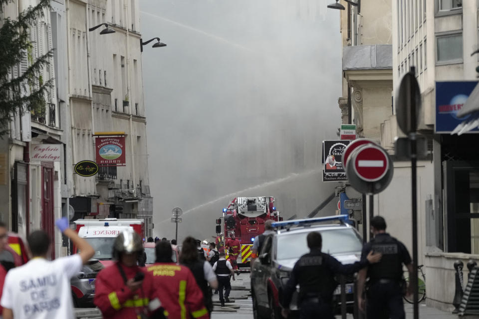 Firemen use a water canon as they fight a blaze Wednesday, June 21, 2023 in Paris. Firefighters fought a blaze on Paris' Left Bank that is sent smoke soaring over the domed Pantheon monument and prompted evacuation of buildings in the neighborhood, police said. Local media cited witnesses describing a large explosion preceding the fire, and saying that part of a building collapsed. (AP Photo/Christophe Ena)