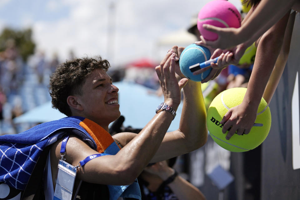 Ben Shelton of the U.S. signs autographs after defeating Roberto Bautista Agut of Spain in their first round match at the Australian Open tennis championships at Melbourne Park, Melbourne, Australia, Monday, Jan. 15, 2024. (AP Photo/Alessandra Tarantino)