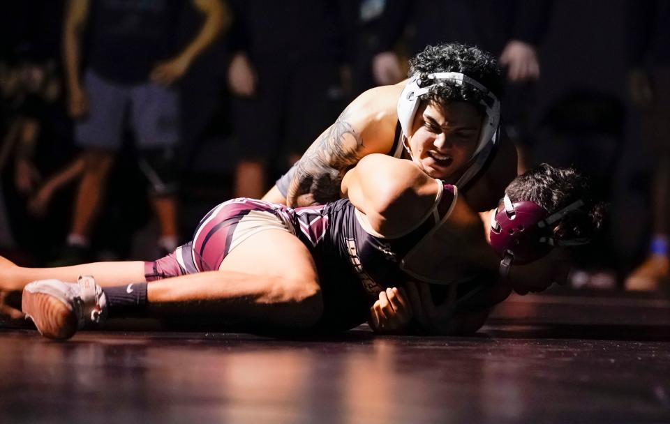 Palmetto Ridge’s Jean Valoria competes against Riverdale’s Samuel Hall during a wrestling match at Palmetto Ridge High School in Naples on Thursday, Jan. 12, 2023.