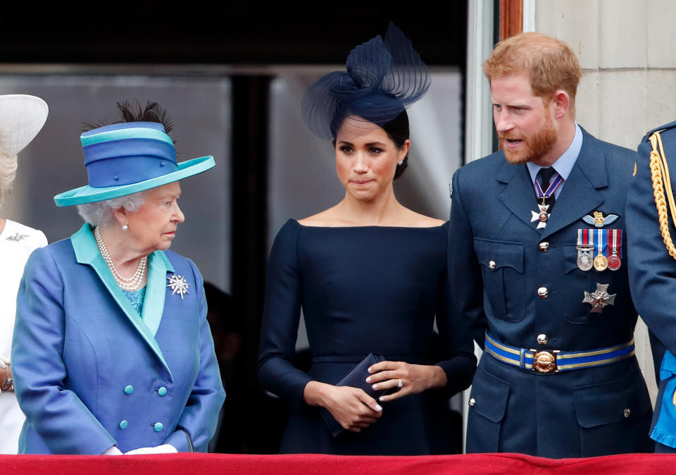 Prince Harry and Meghan Markle look incredulous as Queen Elizabeth looks at then sternly at Trooping the Colour