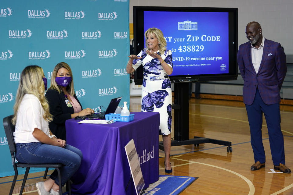 First lady Jill Biden and former Dallas Cowboy and Football Hall of Famer Emmitt Smith tour a vaccination site at Emmett J. Conrad High School in Dallas, Tuesday, June 29, 2021. (AP Photo/Carolyn Kaster, Pool)