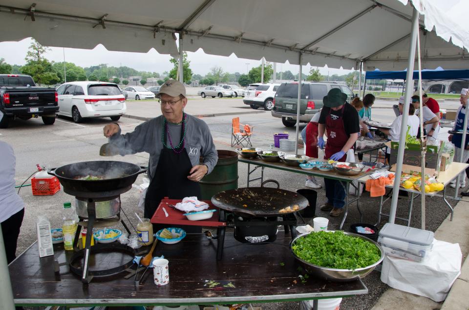 Members of the Rotary Club of Memphis volunteer to cook authentic New Orleans Shrimp & Grits and Beignets for Cafe du Memphis.