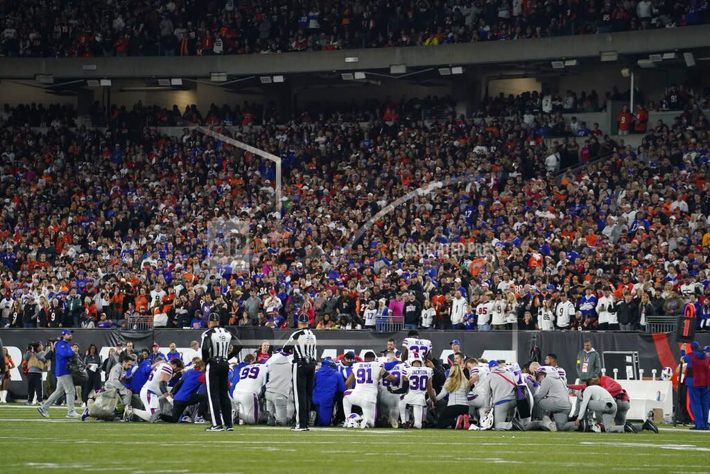 The Buffalo Bills players pray for teammate Damar Hamlin during the first half of an NFL football game against the Cincinnati Bengals, Monday, Jan. 2, 2023, in Cincinnati. (AP Photo/Jeff Dean)