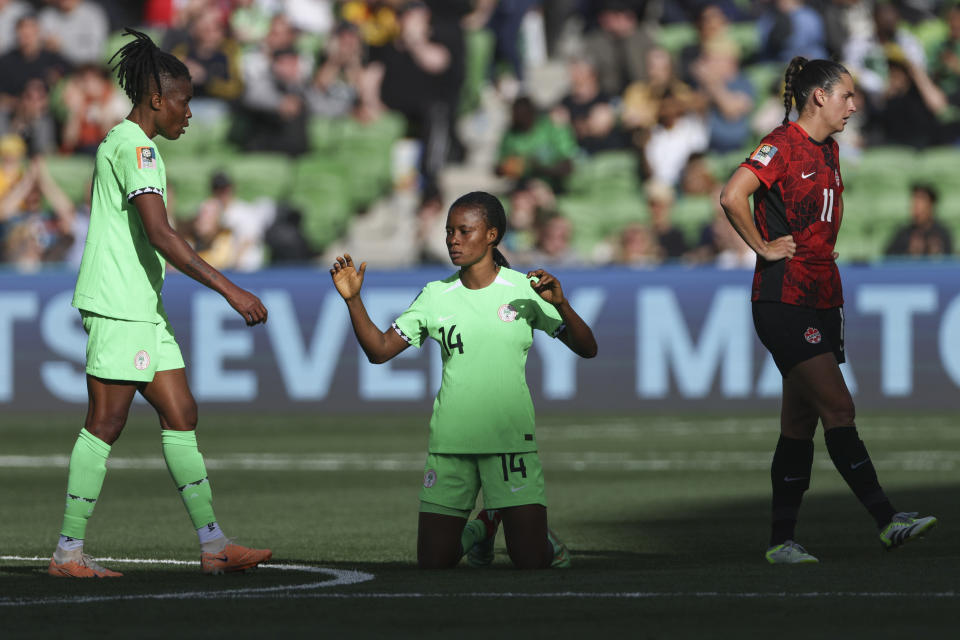 Nigeria's Blessing Demehin and teammate Osinachi Ohale, left, and Canada's Evelyne Viens react following the Women's World Cup Group B soccer match between Nigeria and Canada in Melbourne, Australia, Friday, July 21, 2023. (AP Photo/Hamish Blair)