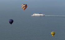 DOVER, UNITED KINGDOM - APRIL 07: Hot air balloons which departed from Lydden Hill race circuit near Canterbury take part in a mass crossing of the Channel on April 7, 2011 in Wootton, England. 51 balloonists of various nationalities from across Europe took off from Kent making for Calais, France at about 7am. It is the first time a Guinness World Record bid has been made for "the largest group of hot air balloons to make the Channel crossing". (Photo by Oli Scarff/Getty Images)